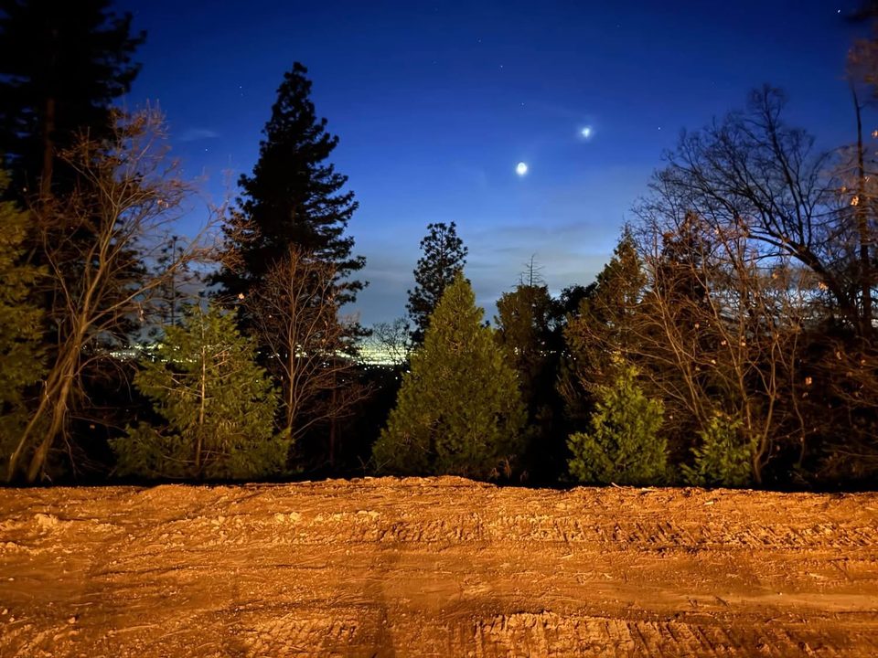 Freshly graded earth among the pines — work underway on the mountain property where THE CAMPUS will be built